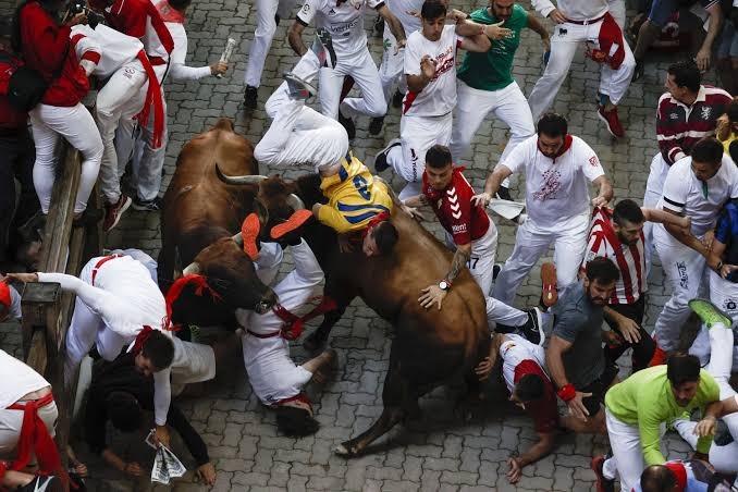 HT1. Pamplona bull-runners trampled with at least three injured
