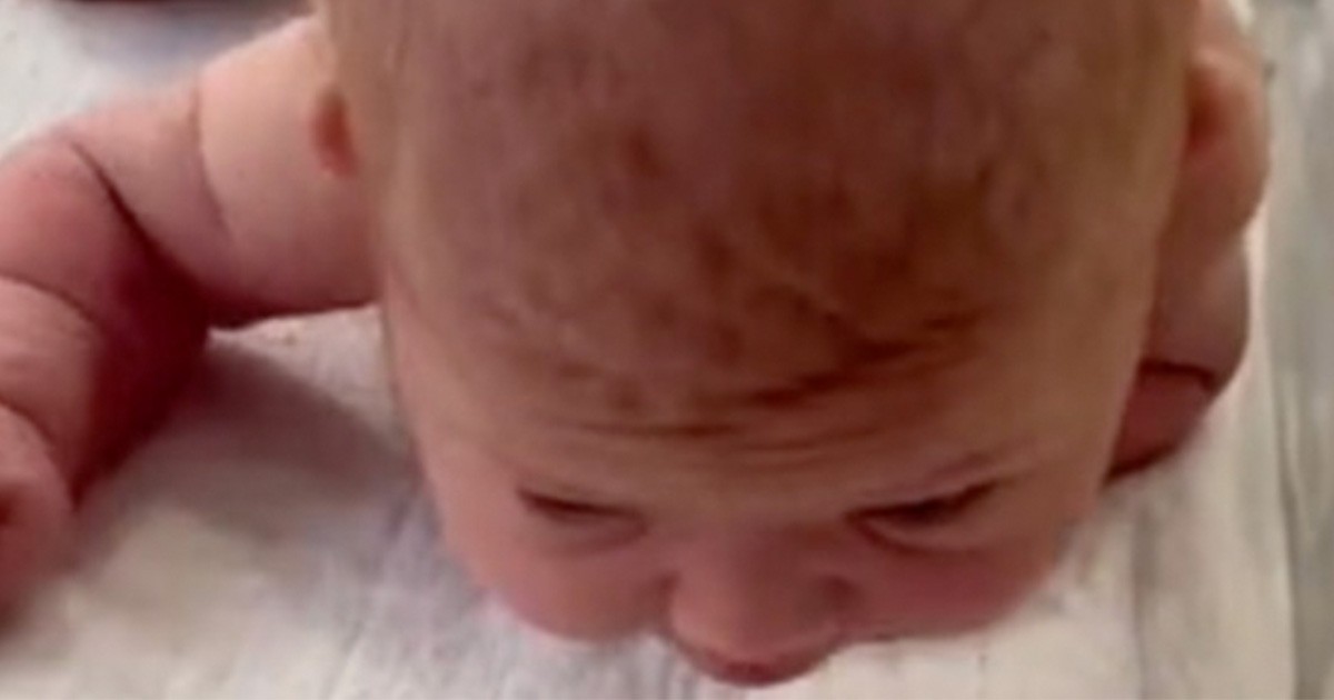 HT1. Newborn baby crawls across the hospital cot